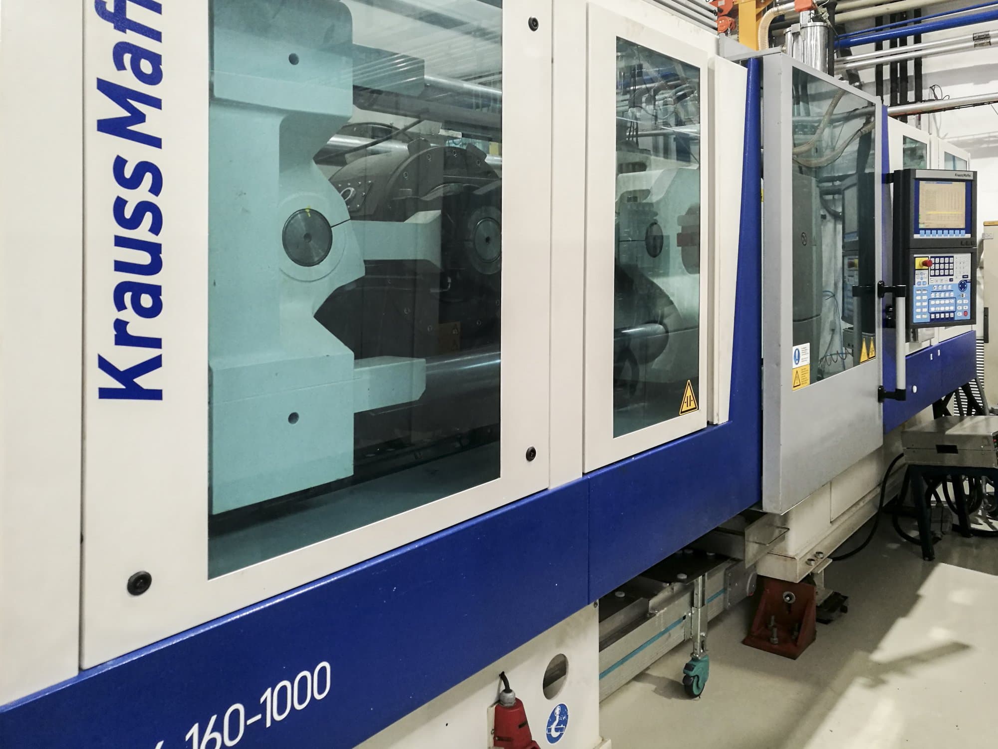 Vista lato sinistro della macchina Krauss Maffei 160-1000 EX